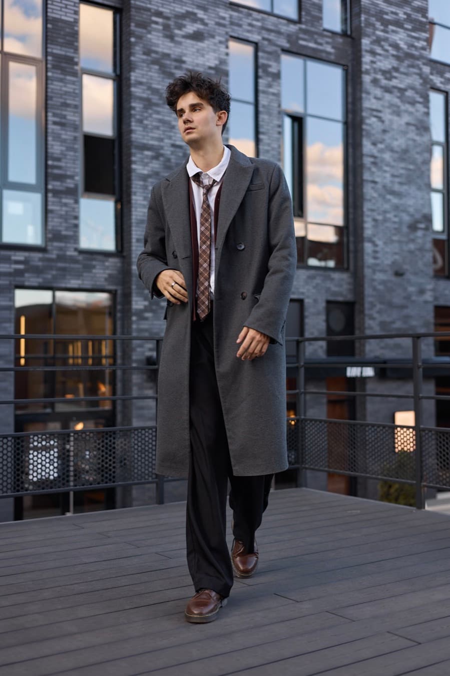 Street fashion frame, grey overcoat and tie, glass building behind