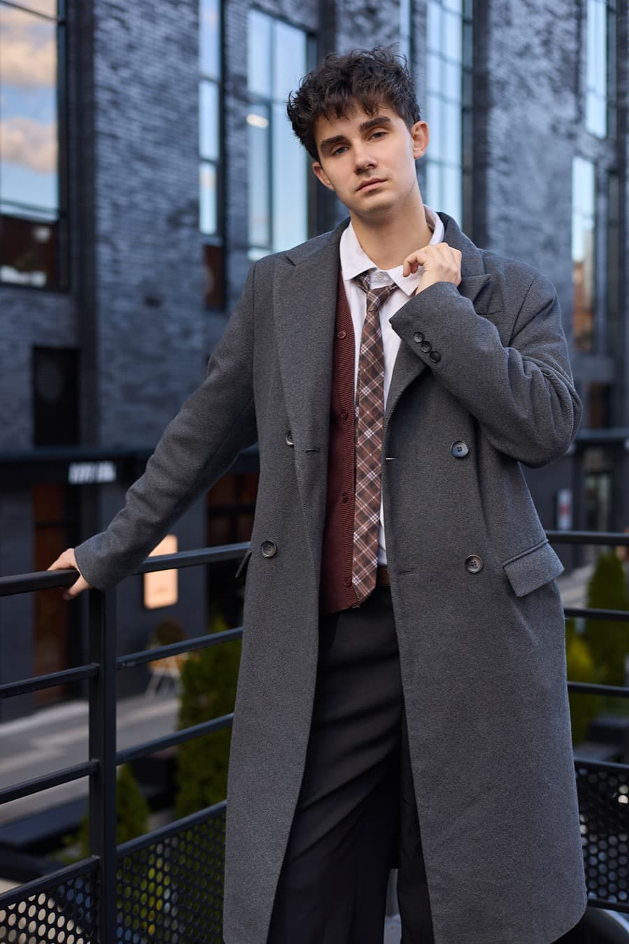 Street portrait at a railing, grey overcoat and patterned tie