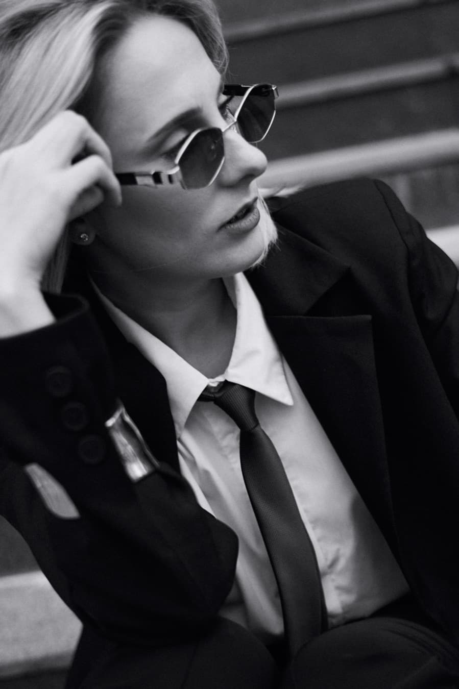Black and white portrait in sunglasses, blazer and tie