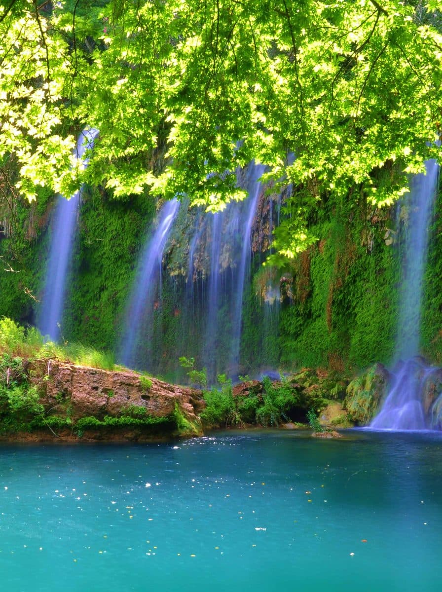 Kurşunlu waterfall falling into a turquoise pool through green forest, near Antalya